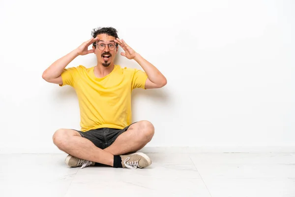 Young Caucasian Man Sitting Floor Isolated White Background Surprise Expression — Stockfoto