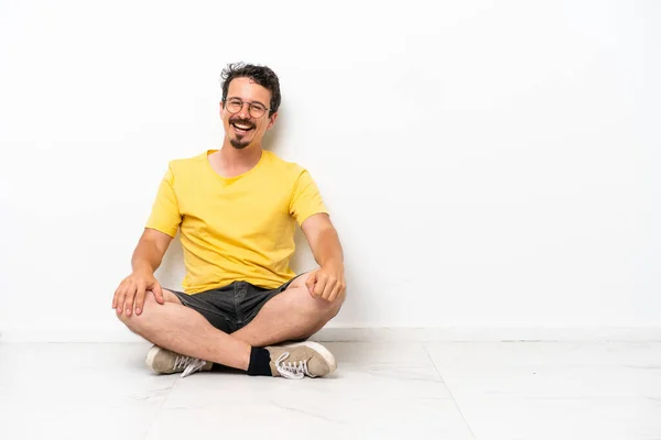 Young Caucasian Man Sitting Floor Isolated White Background Glasses Happy — Foto de Stock