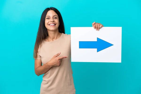 Young Woman Isolated Background Holding Placard Arrow Symbol Pointing — Stock fotografie