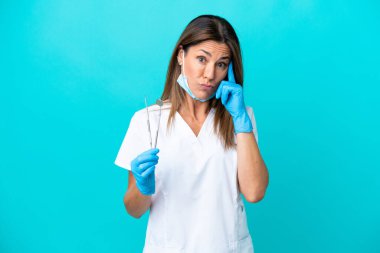 Middle age doctor woman isolated on blue background thinking an idea