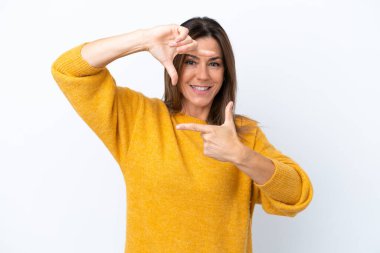 Middle age caucasian woman isolated on white background focusing face. Framing symbol