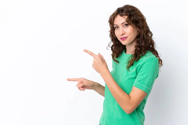 Young Woman Curly Hair Isolated White Background Pointing Finger Side — ストック写真