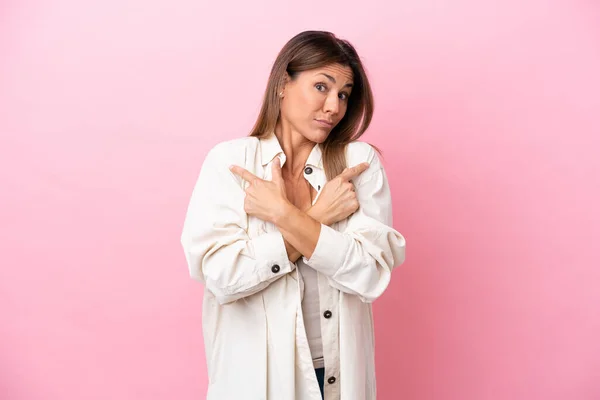 Middle Age Caucasian Woman Isolated Pink Background Pointing Laterals Having — ストック写真