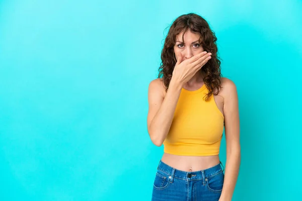 Young Woman Curly Hair Isolated Blue Background Covering Mouth Hand — Stockfoto