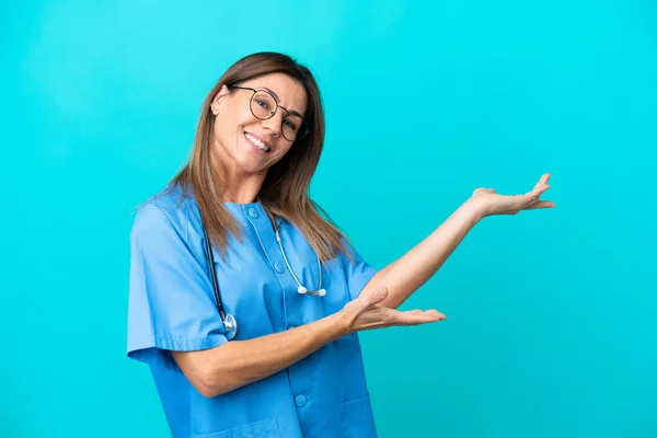 Middle Age Surgeon Woman Isolated Blue Background Extending Hands Side — 图库照片