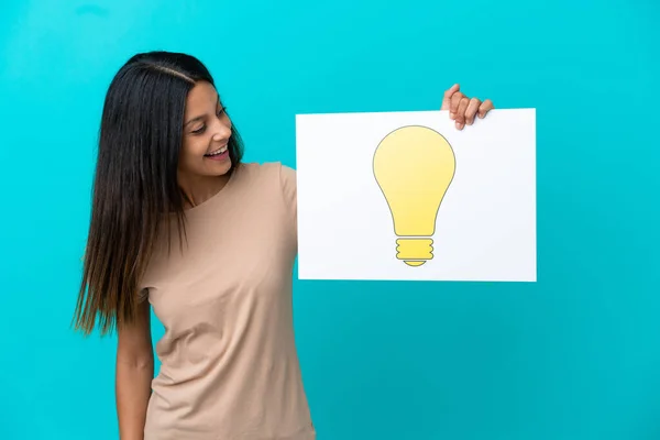 Young Woman Isolated Background Holding Placard Bulb Icon — Stockfoto