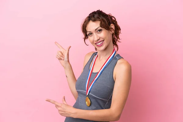 Young Caucasian Woman Medals Isolated Pink Background Pointing Finger Side —  Fotos de Stock