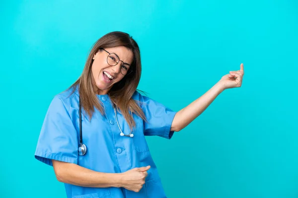 Middle Age Surgeon Woman Isolated Blue Background Making Guitar Gesture — 图库照片