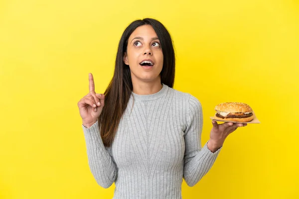 Young Caucasian Woman Holding Burger Isolated Yellow Background Thinking Idea — Fotografia de Stock