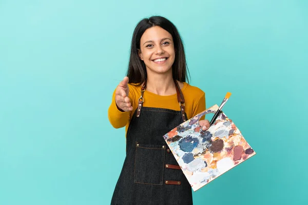 Young Artist Caucasian Woman Holding Palette Isolated Blue Background Shaking —  Fotos de Stock