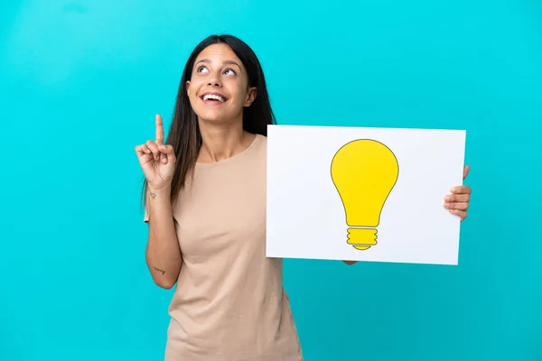 Young Woman Isolated Background Holding Placard Bulb Icon Thinking — Stockfoto