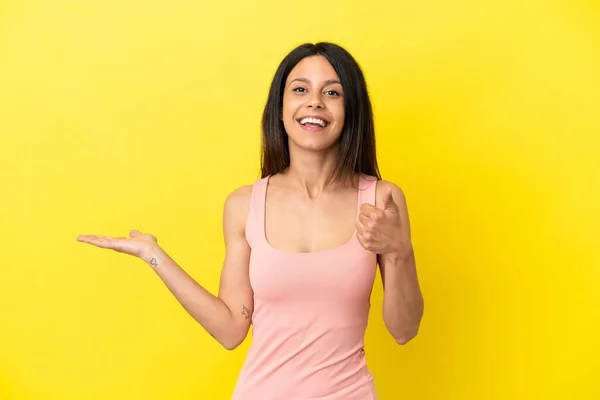 Young Caucasian Woman Isolated Yellow Background Holding Copyspace Imaginary Palm — Stock Photo, Image