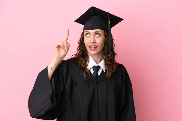 Young university graduate woman isolated on pink background intending to realizes the solution while lifting a finger up