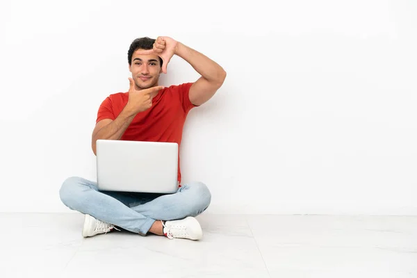 Caucasian Handsome Man Laptop Sitting Floor Focusing Face Framing Symbol — Zdjęcie stockowe