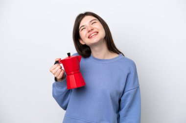 Young Russian woman holding coffee pot isolated on white background laughing