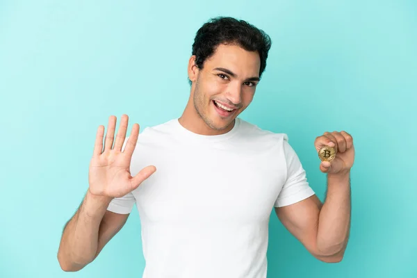 Young Man Holding Bitcoin Isolated Blue Background Saluting Hand Happy — 스톡 사진