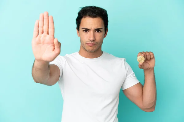 Young Man Holding Bitcoin Isolated Blue Background Making Stop Gesture — Stock fotografie
