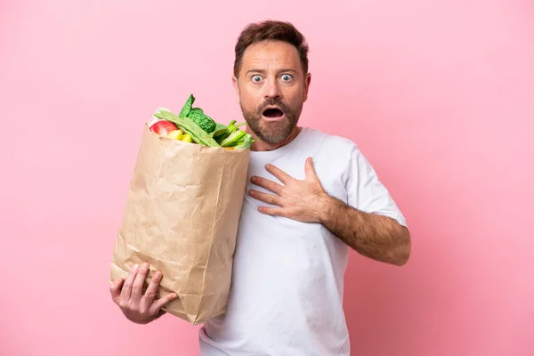 Middle Age Man Holding Grocery Shopping Bag Isolated Pink Background — Φωτογραφία Αρχείου