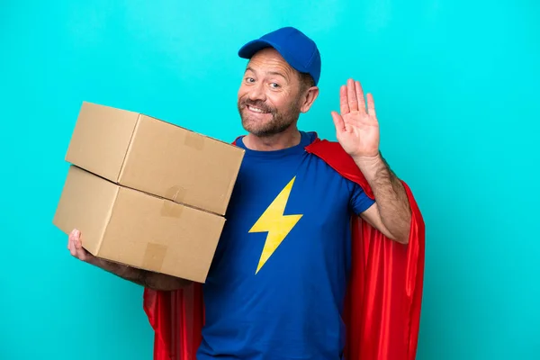 Super Hero Delivery Man Isolated Blue Background Saluting Hand Happy — Stok fotoğraf