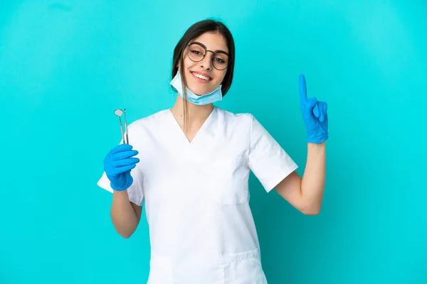Young Caucasian Dentist Woman Holding Tools Isolated Blue Background Showing — 图库照片