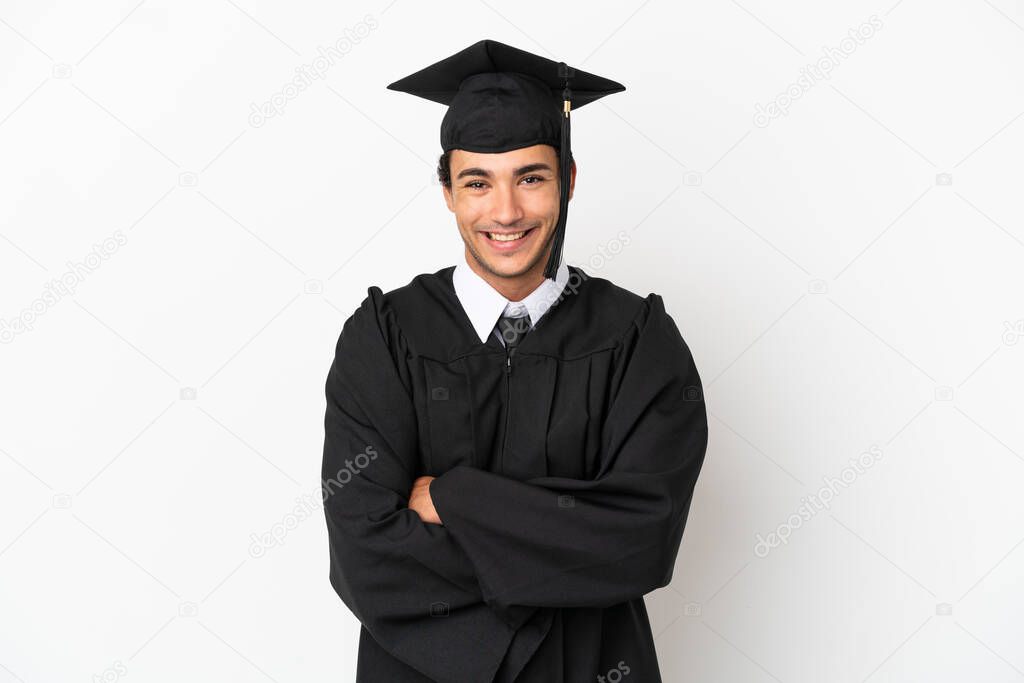 Young university graduate over isolated white background keeping the arms crossed in frontal position