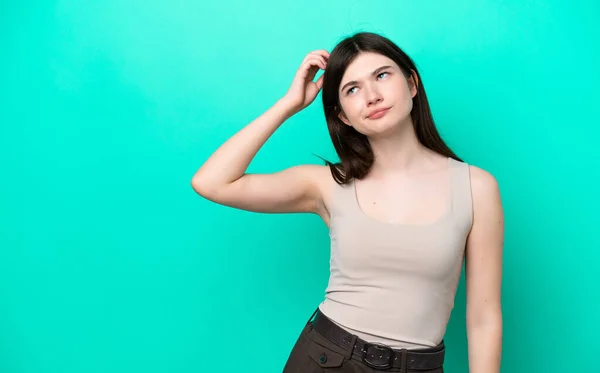 Young Russian Woman Isolated Green Background Having Doubts While Scratching — Foto de Stock