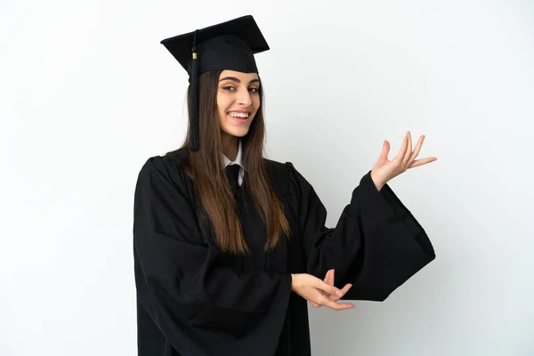 Joven Graduado Universitario Aislado Sobre Fondo Blanco Extendiendo Las Manos — Foto de Stock