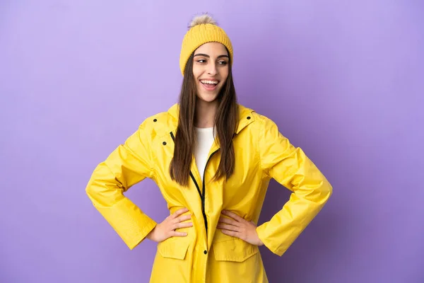 Young Caucasian Woman Wearing Rainproof Coat Isolated Purple Background Posing —  Fotos de Stock
