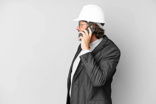 Young Architect Man Helmet Isolated Background Keeping Conversation Mobile Phone — Stock fotografie