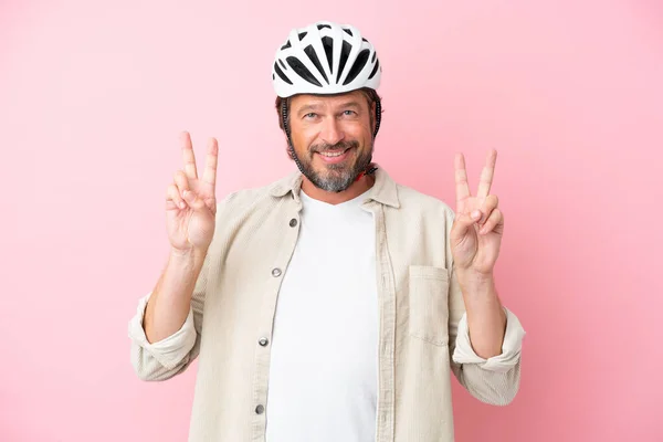 Senior Dutch Man Bike Helmet Isolated Pink Background Showing Victory — Fotografia de Stock