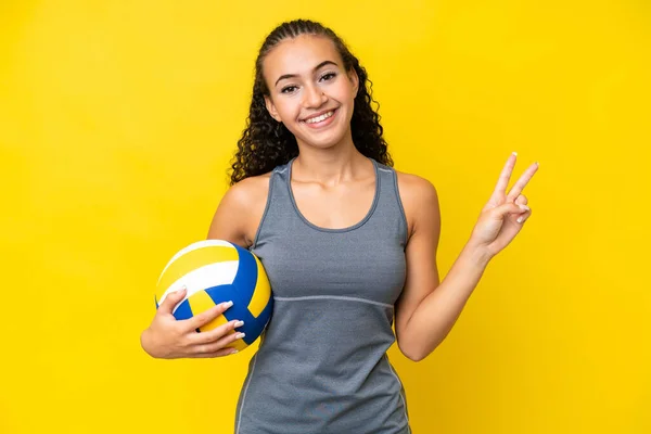 Young Woman Playing Volleyball Isolated Yellow Background Smiling Showing Victory — Stok fotoğraf