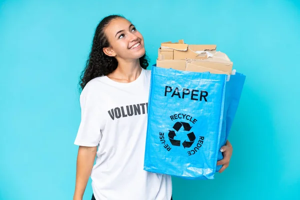 Young Woman Holding Recycling Bag Full Paper Recycle Isolated Blue — Stockfoto