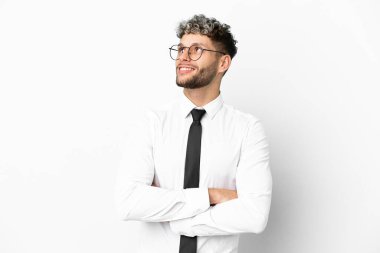 Business caucasian man isolated on white background looking up while smiling