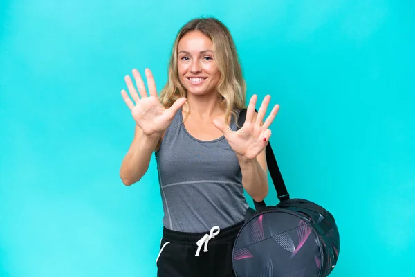 Young Sport Woman Sport Bag Isolated Blue Background Counting Nine — Stockfoto
