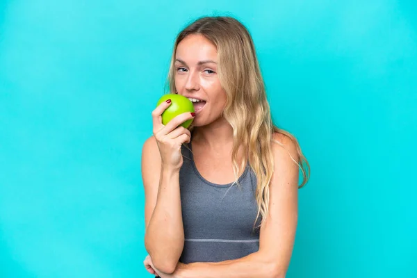 Young Russian Woman Isolated Blue Background Eating Apple — Stock fotografie