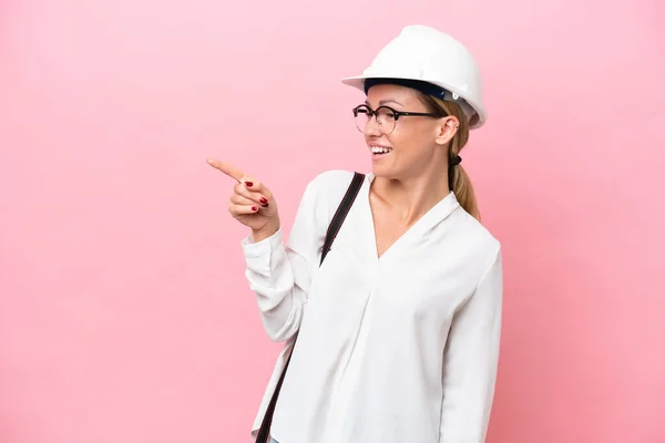 Young Architect Russian Woman Helmet Holding Blueprints Isolated Pink Background — Stok fotoğraf