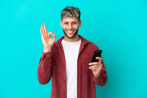 Young Handsome Caucasian Man Isolated Blue Background Using Mobile Phone — 스톡 사진