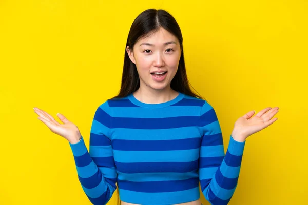 Young Chinese Woman Isolated Yellow Background Shocked Facial Expression —  Fotos de Stock