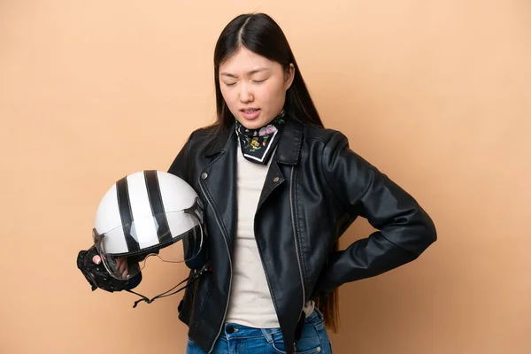 Young Chinese Woman Motorcycle Helmet Isolated Beige Background Suffering Backache — Stockfoto