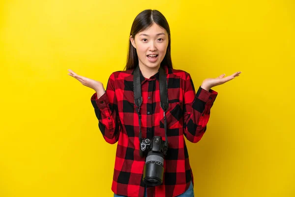 Young Photographer Chinese Woman Isolated Yellow Background Shocked Facial Expression —  Fotos de Stock