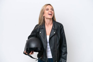 Pretty blonde woman with a motorcycle helmet isolated on white background laughing