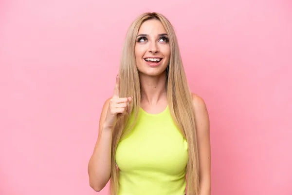 Pretty Blonde Woman Isolated Pink Background Pointing Surprised — стоковое фото