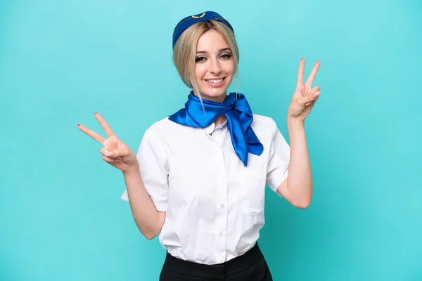 Airplane Blonde Stewardess Woman Isolated Blue Background Showing Victory Sign — Stock Photo, Image