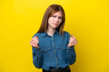 Sarı arka planda izole edilmiş genç bir İngiliz kadın para hareketi yapıyor ama mahvoldu.