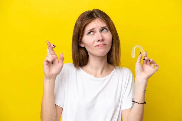 Young English Woman Holding Invisible Braces Fingers Crossing Wishing Best — ストック写真