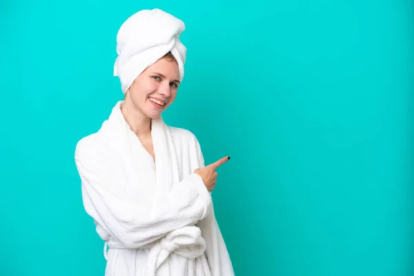 Young Woman Bathrobe Isolated Blue Background Pointing Back — Foto Stock