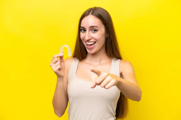 Young Caucasian Woman Holding Invisible Braces Isolated Yellow Background Points — 图库照片