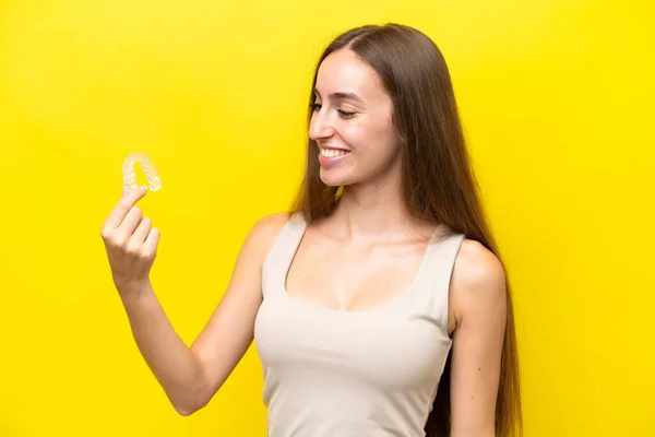 Young Caucasian Woman Holding Invisible Braces Isolated Yellow Background Happy — Φωτογραφία Αρχείου