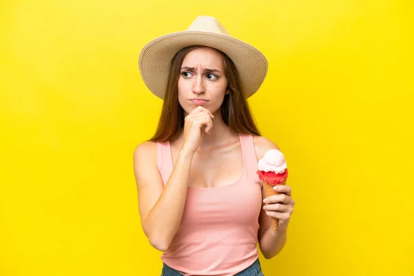 Young Caucasian Cornet Ice Cream Isolated Yellow Background Having Doubts — Φωτογραφία Αρχείου