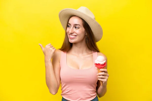 Young Caucasian Cornet Ice Cream Isolated Yellow Background Pointing Side — Φωτογραφία Αρχείου